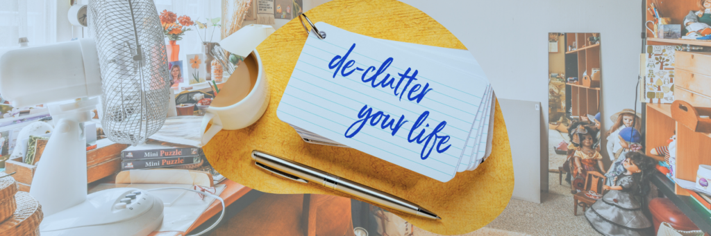 A photograph of an untidy room with a cluttered desk. The image is overlaid with an organic shape showing a stack of notecards on which is written 'de-clutter your life', alongside a writing pen and a semi-visible cup of hot beverage.